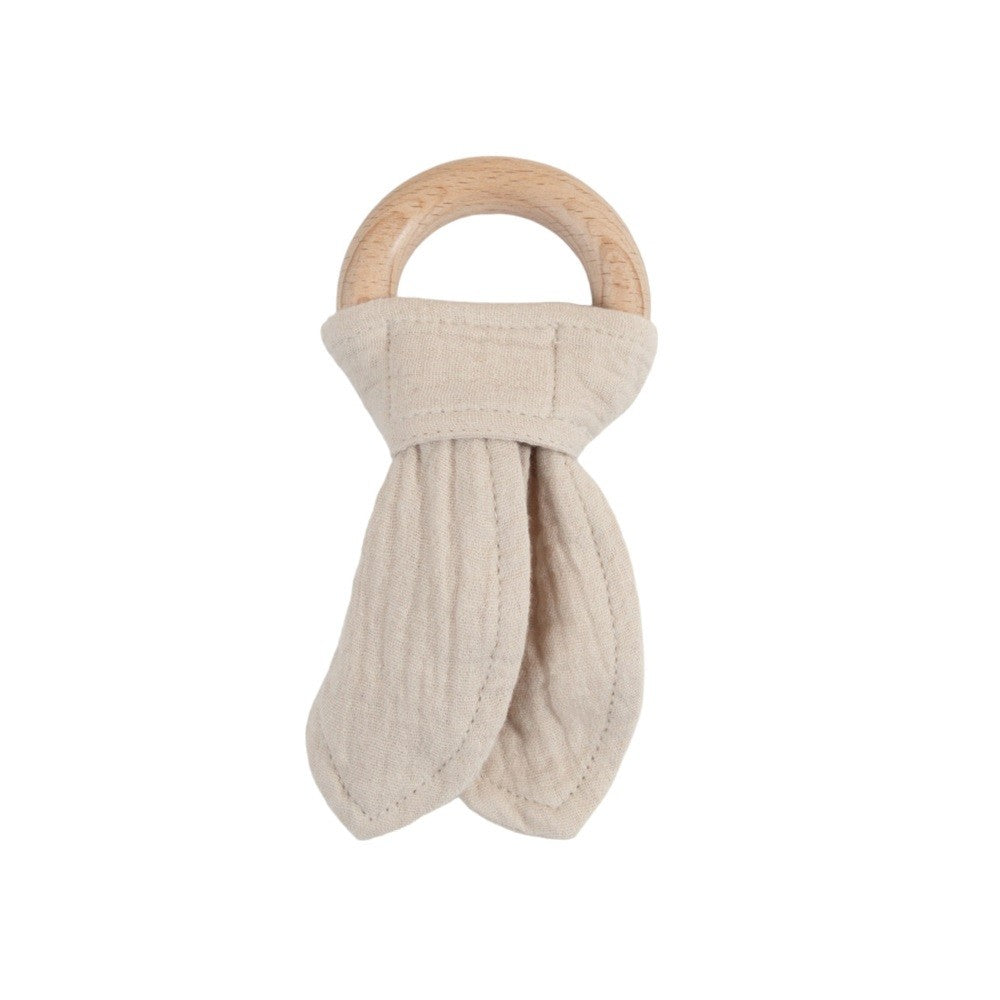 Beige cotton muslin teething ring with wooden handle on a white background