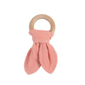 Pink cotton muslin fabric teether with wooden ring on a white background