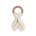 Baby teething ring with wooden handle and white fabric on a white background