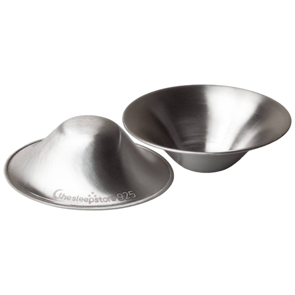 Two silver soothing nipple cups on a white background