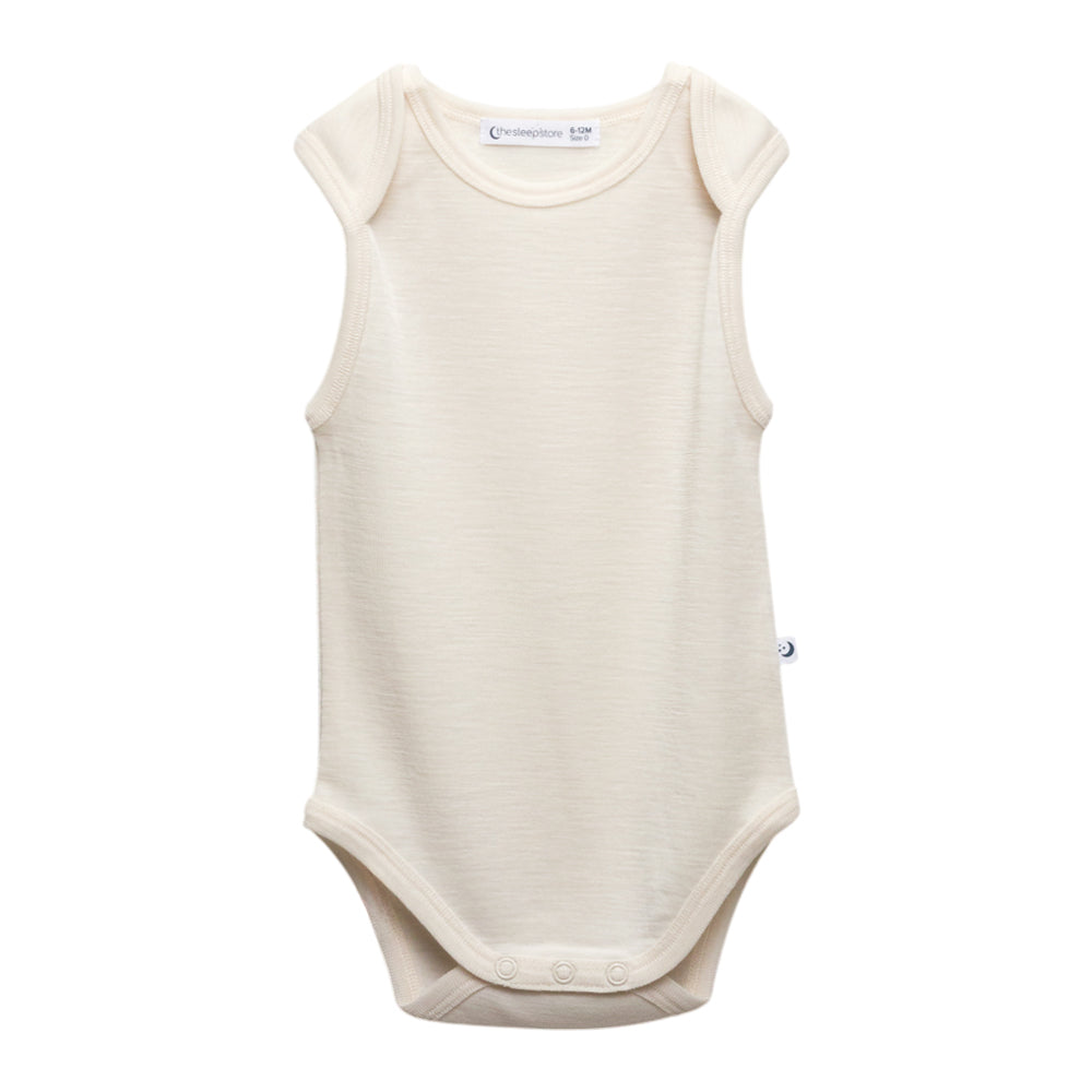 An off-white sleeveless deluxe merino  baby singletsuit with a crew neck and snap closures at the crotch, shown against a plain white background.