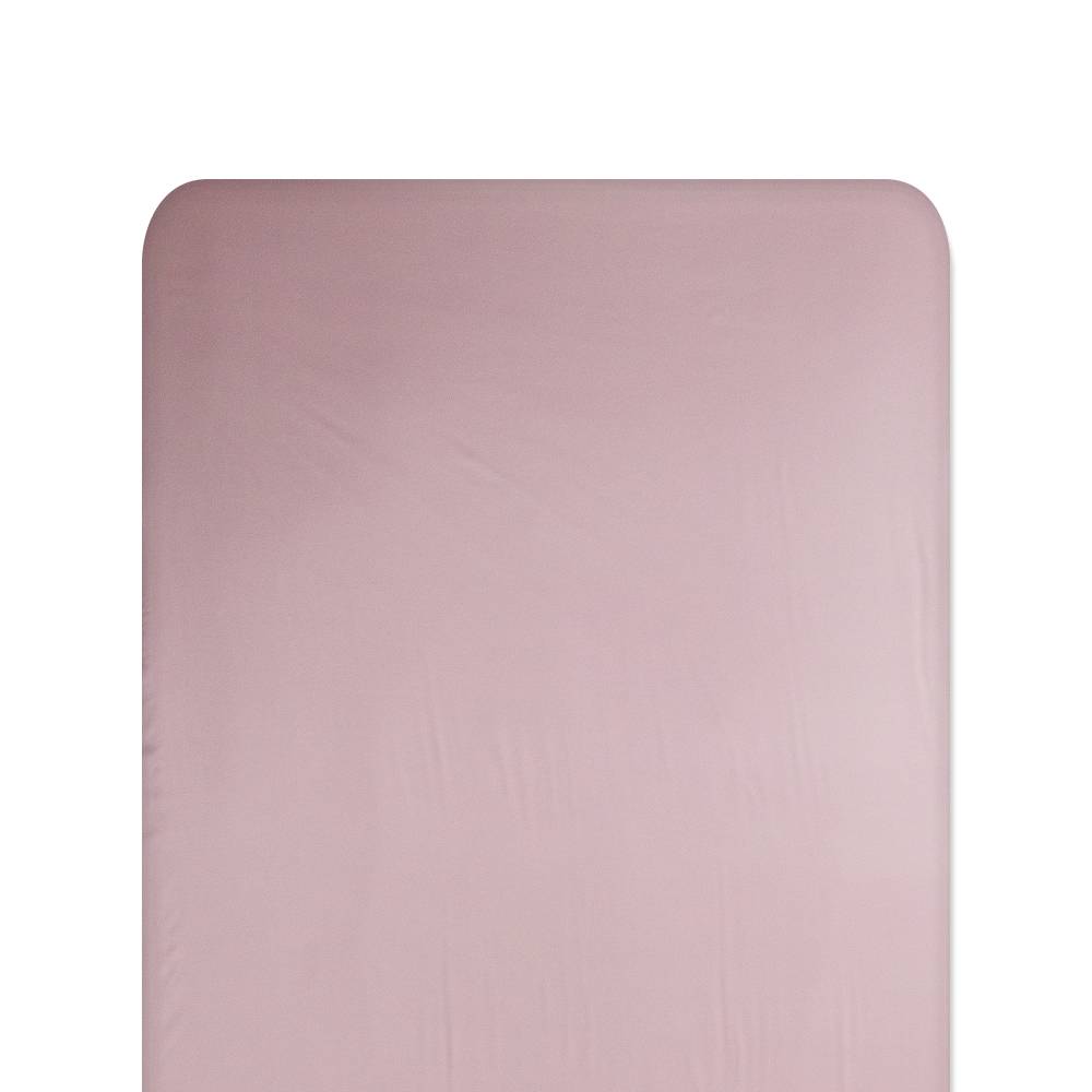 Pink silk fitted sheet on a white background