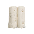 Two folded baby swaddle blankets with bee design and owl designs on a white background