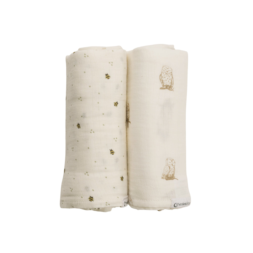 Two folded baby swaddle blankets with bee design and owl designs on a white background