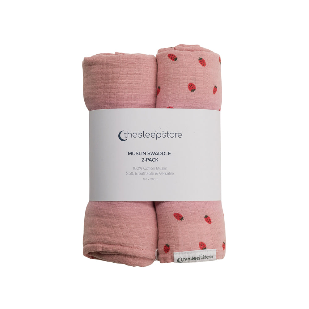 Two pink muslin swaddles with red strawberry pattern in packaging labeled 'thesleepstore'.