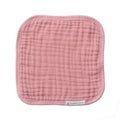 Pink muslin face cloth on a white background