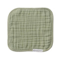 Green textured face cloth with 'thesleepstore' label on a white background
