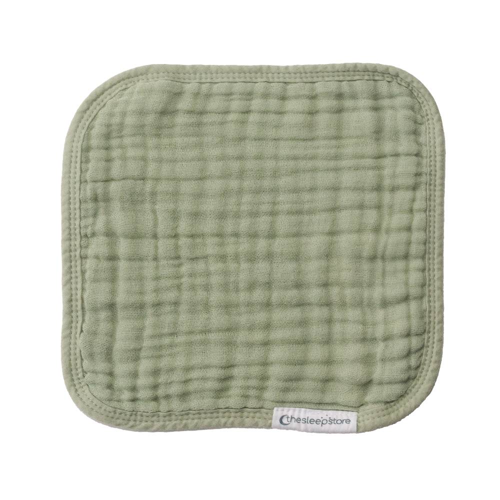 Green textured face cloth with 'thesleepstore' label on a white background