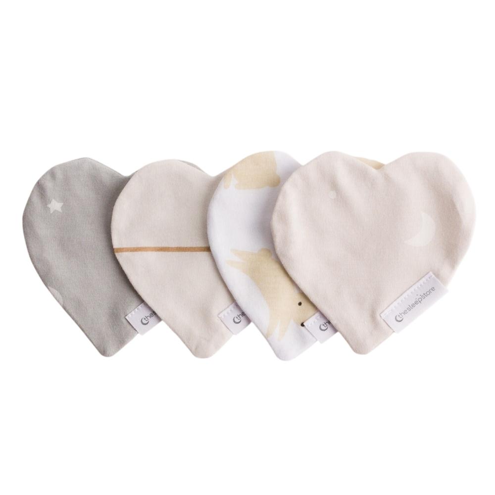 Four heart-shaped comforters in different colors on a white background