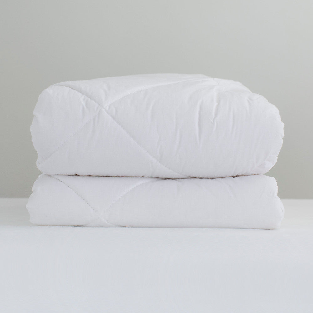 2 wool Duvet inners stacked on a white background
