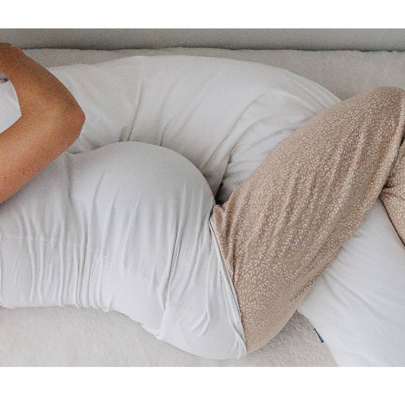Pregnancy pillow between the legs of a pregnant women sleeping