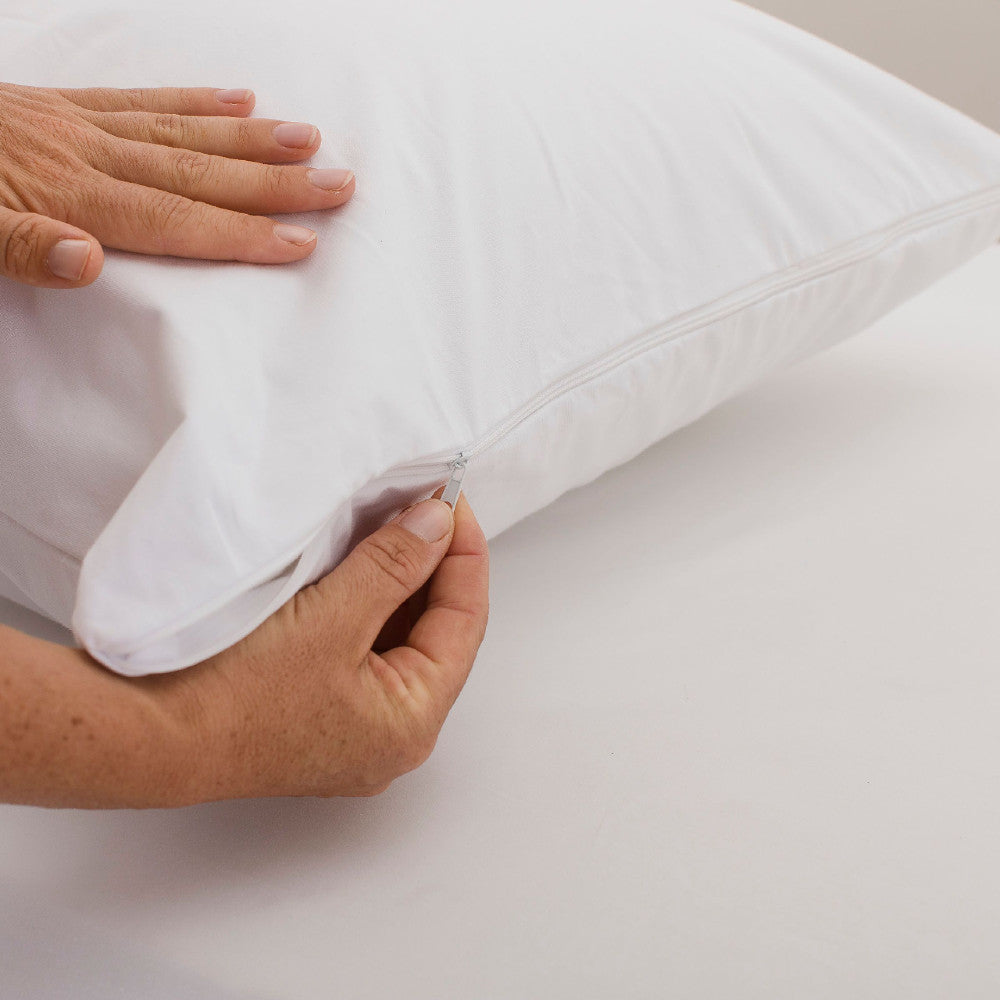 White pillow protector on a light gray background