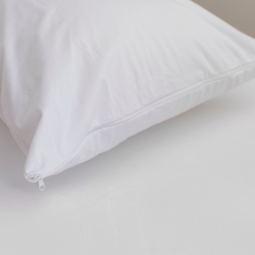 White pillow protector on a light gray background