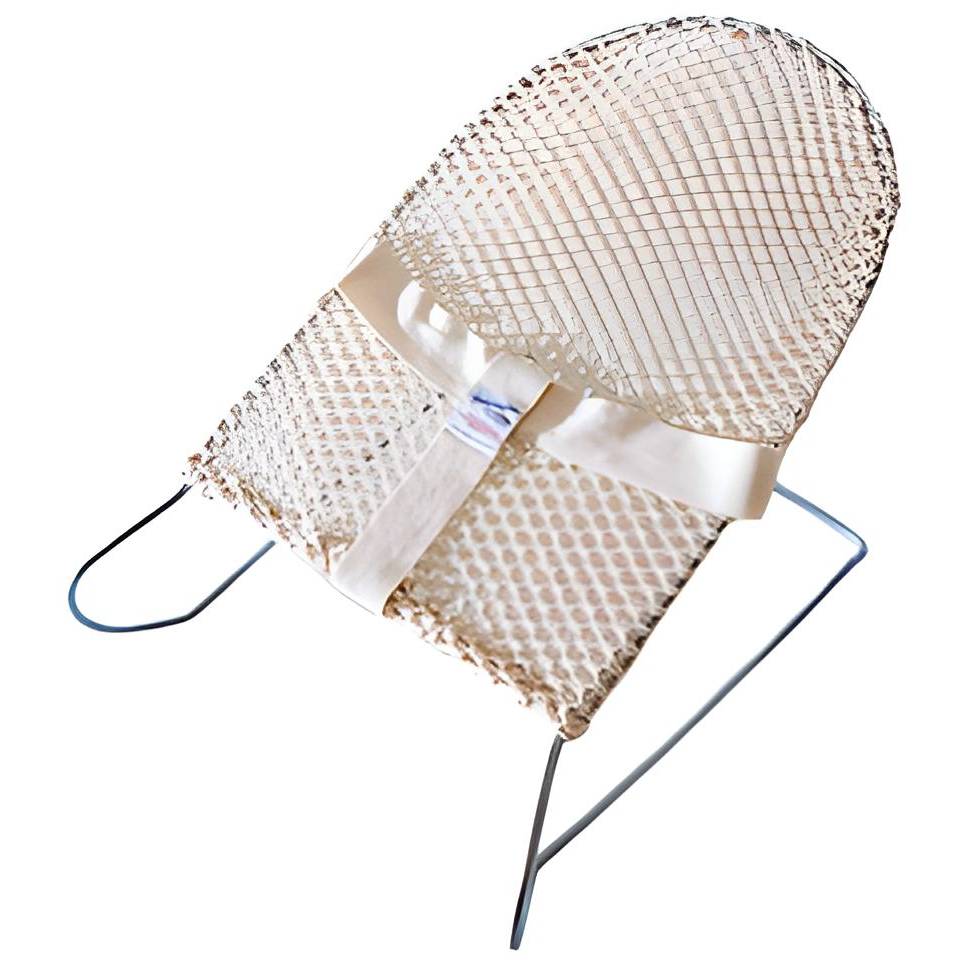 Baby bouncer with cream cover against white background.