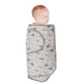 Baby wrapped in a grey owl patterned miracle blanket swaddle on a white background