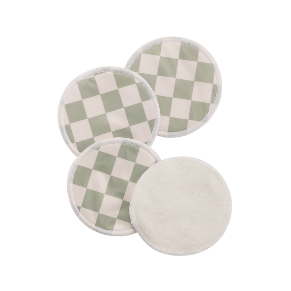 Four round checkered breast pads with green and white pattern on a white background
