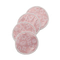 Set of pink reusable breast pads with white patterns on a white background
