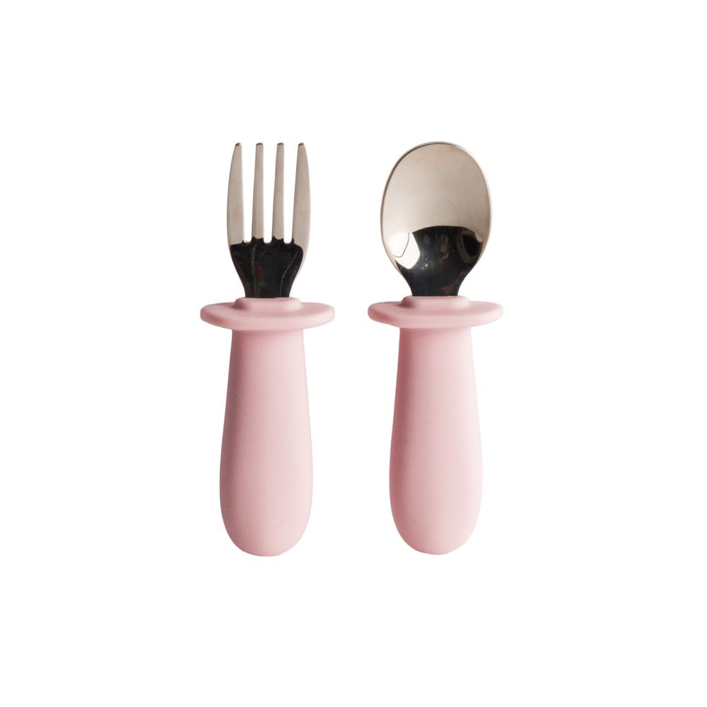 Set of pink baby's fork and spoon with silicone handles on a white background