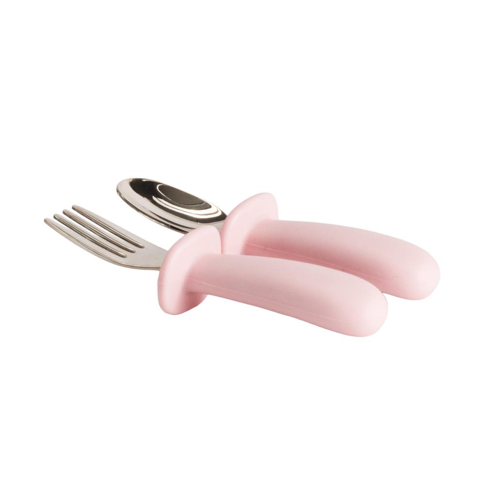 Pink baby fork and spoon set set on a white background