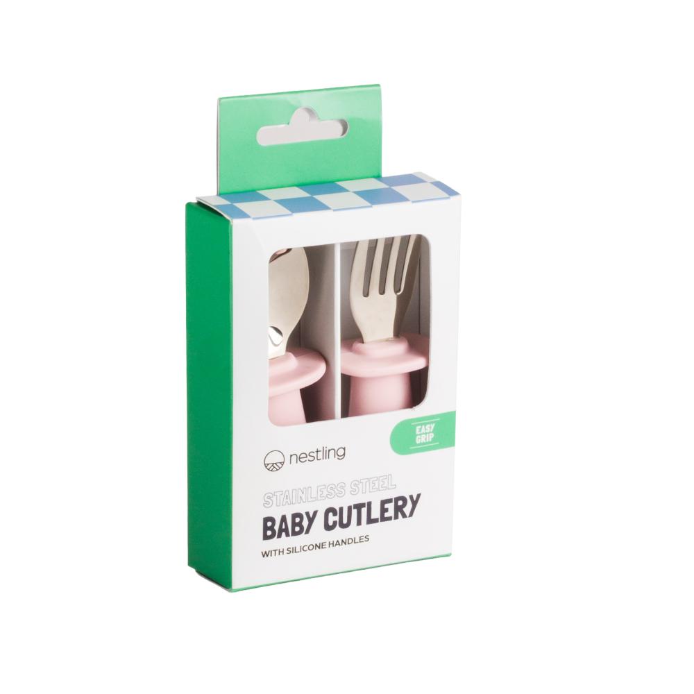 Box of Nestling baby cutlery with pink silicone handles on a white background