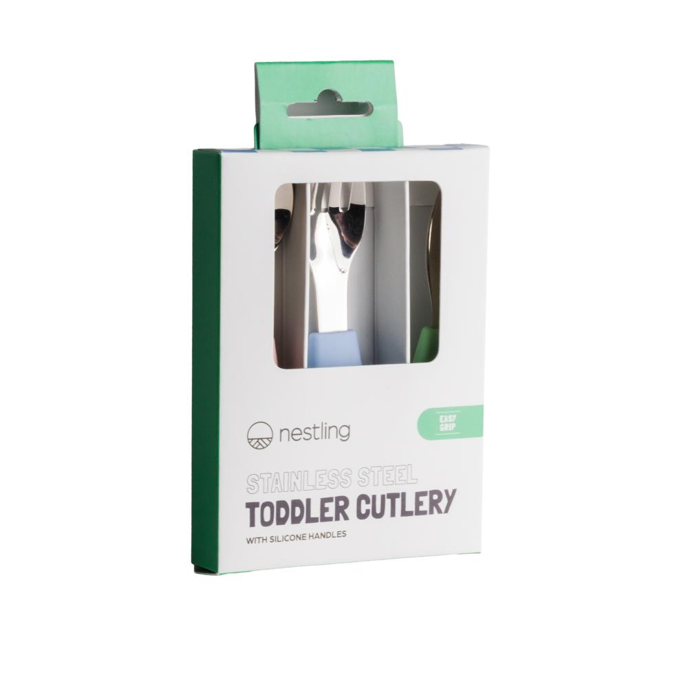 Packaged toddler cutlery set with 'nestling' branding on a white background