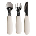 Set of Nestling stainless steel cutlery with oat silicone handles on a white background