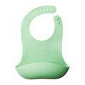 Green silicone bib on a white background