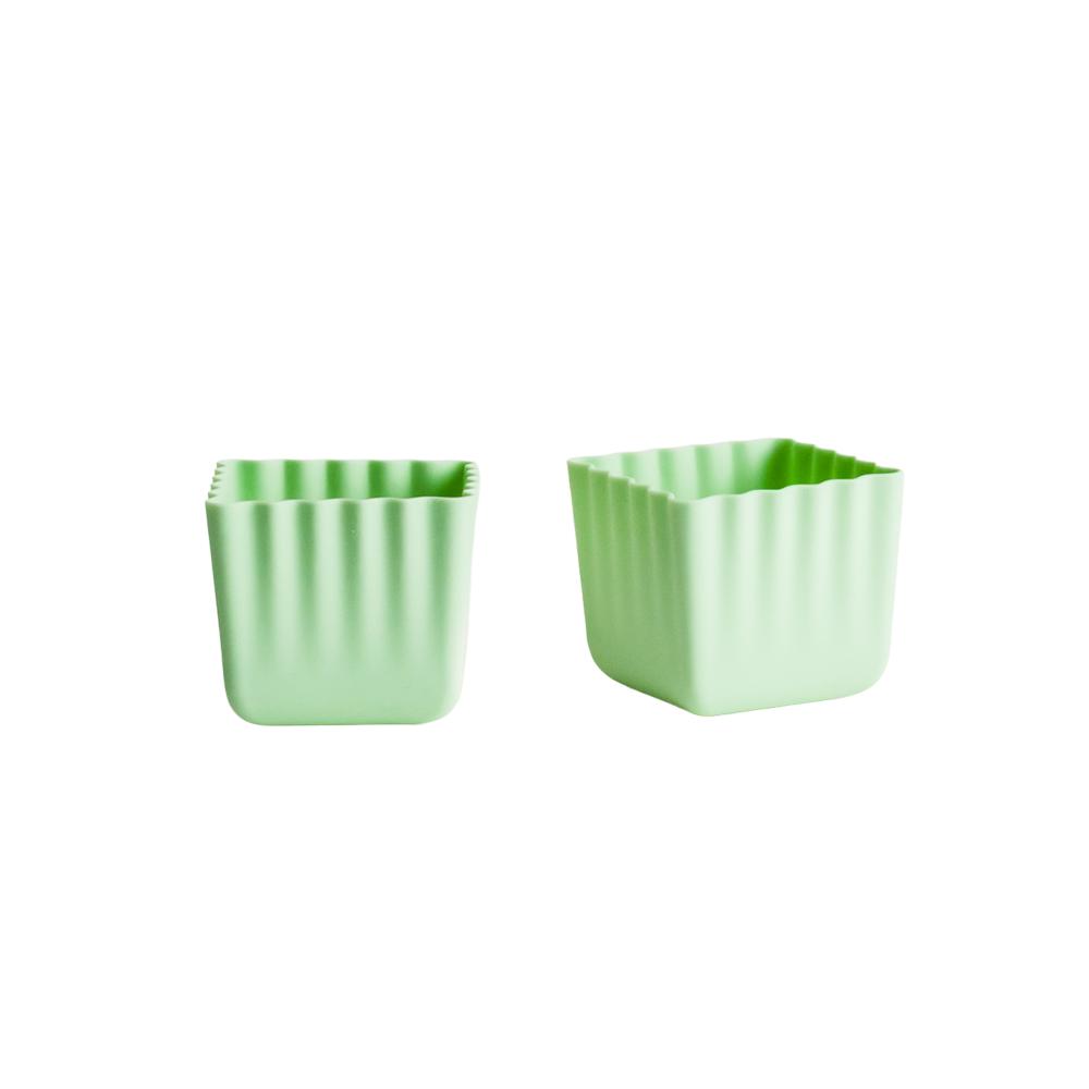 2 green Silicone cups on a white background