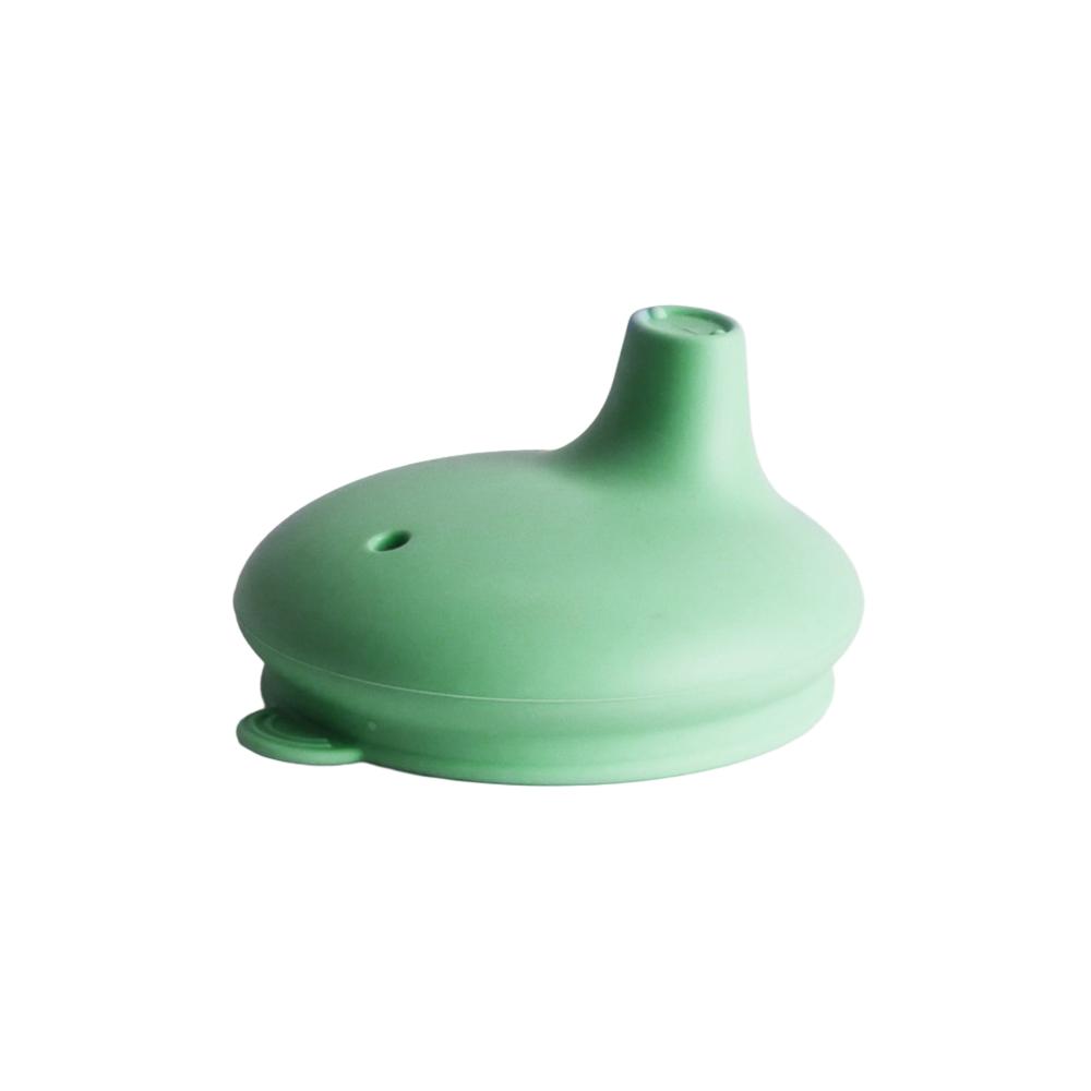 Green silicone sippy cup lid on a white background