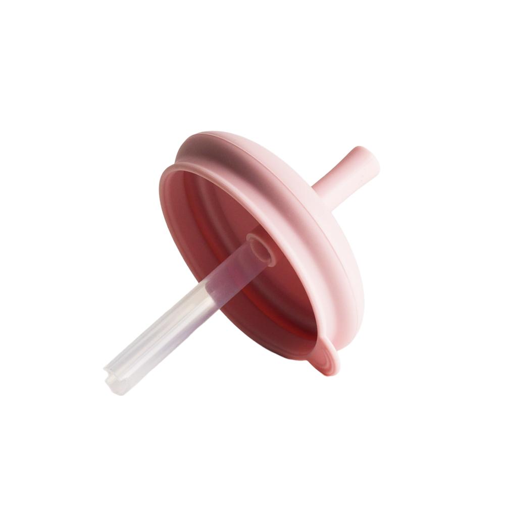 Pink silicone lid with a straw on a white background