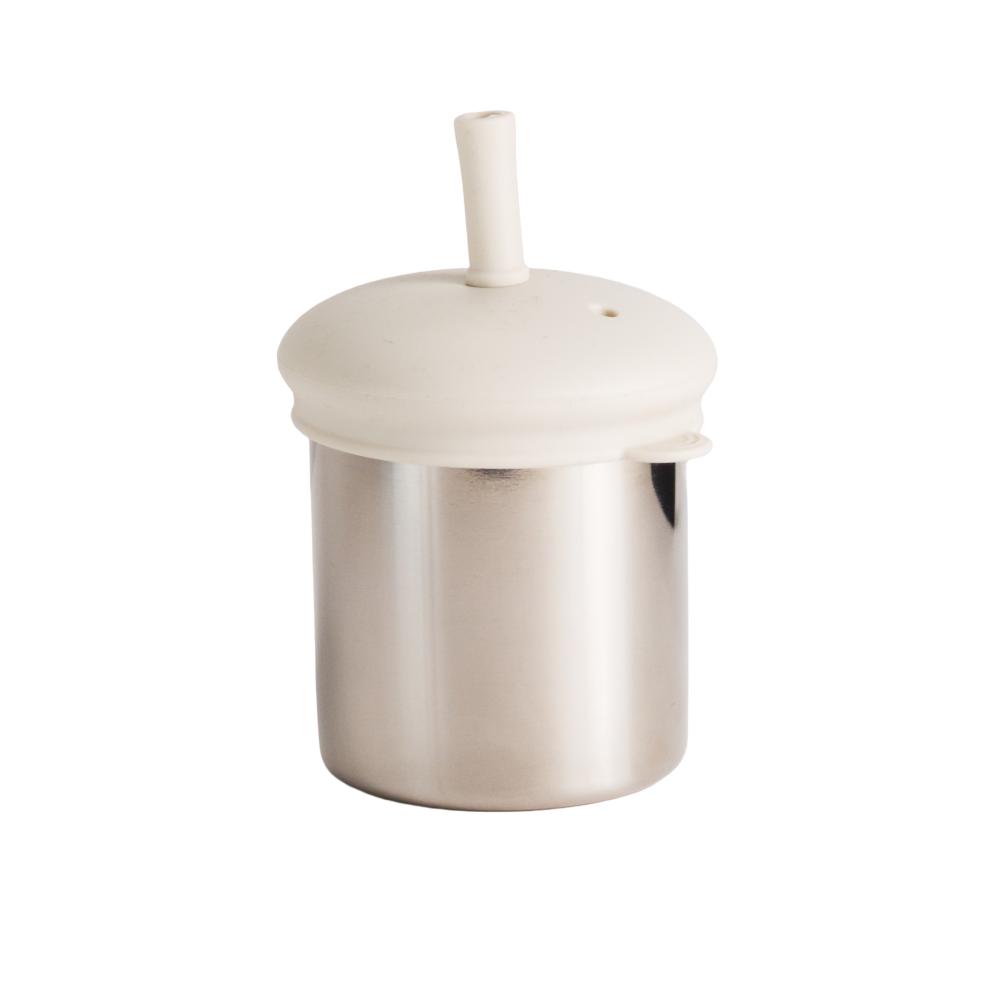 Nestling stainless steel sippy cup with an oat colour straw lid on a white background