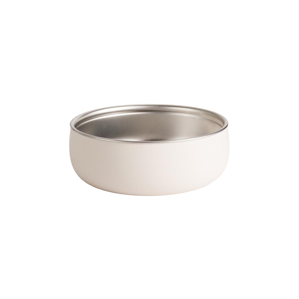 Stainless steel bowl with oat colour silicone outer on a white background