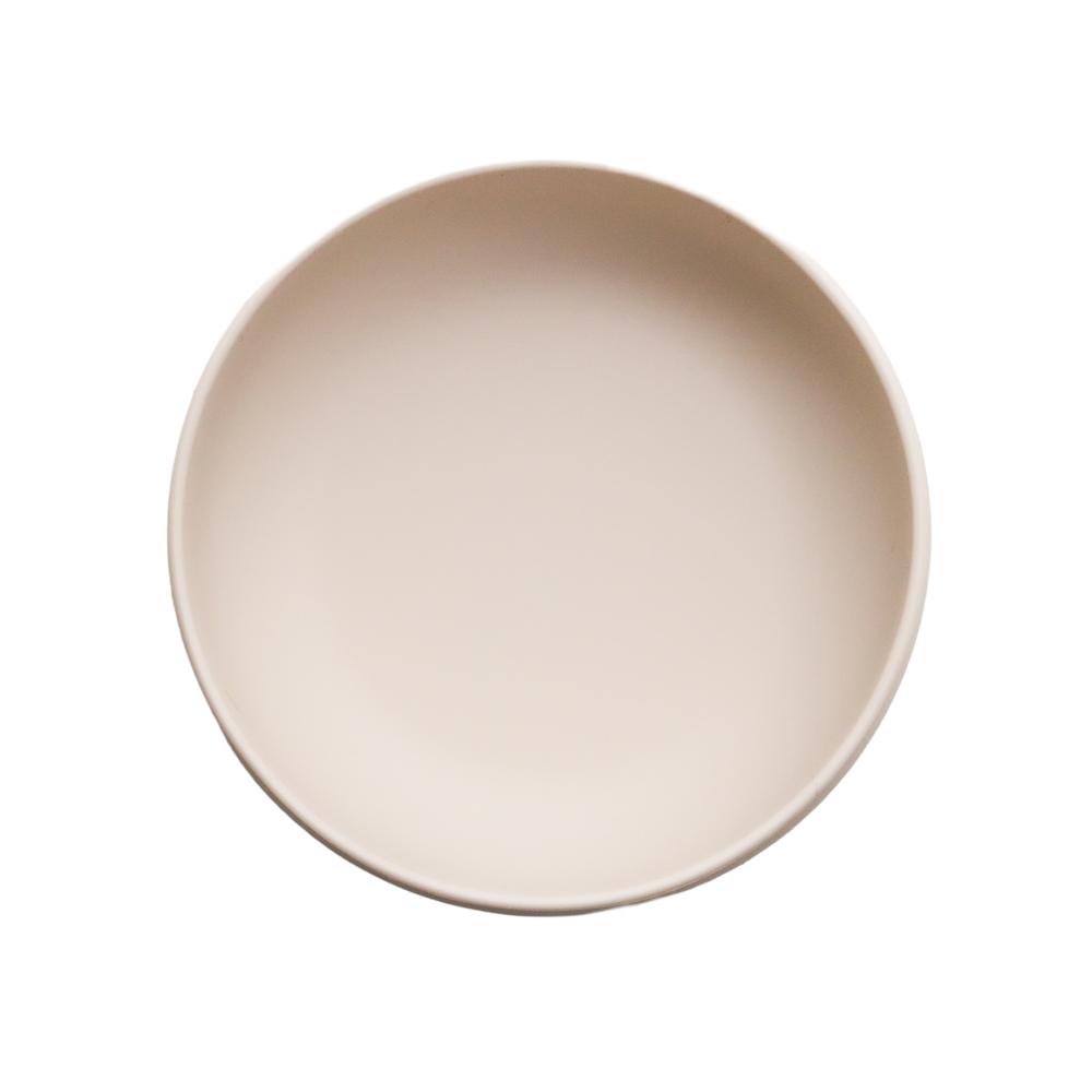 Oat coloured silicone bowl outer on a white background