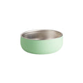 Nestling green large stainless steel and silicone bowl on a white background