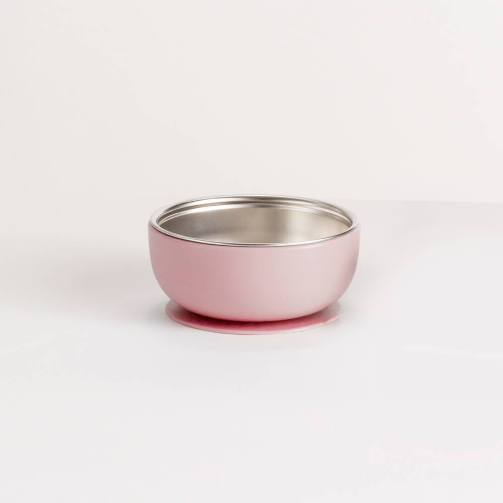 Pink silicone and stainless steel baby feeding bowl on a white background
