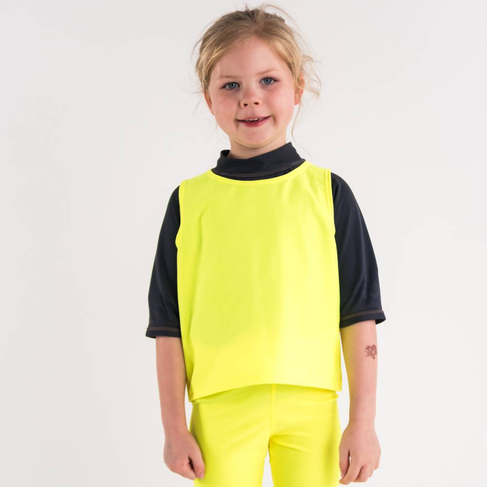 Child wearing a bright yellow swim vest  on a white background