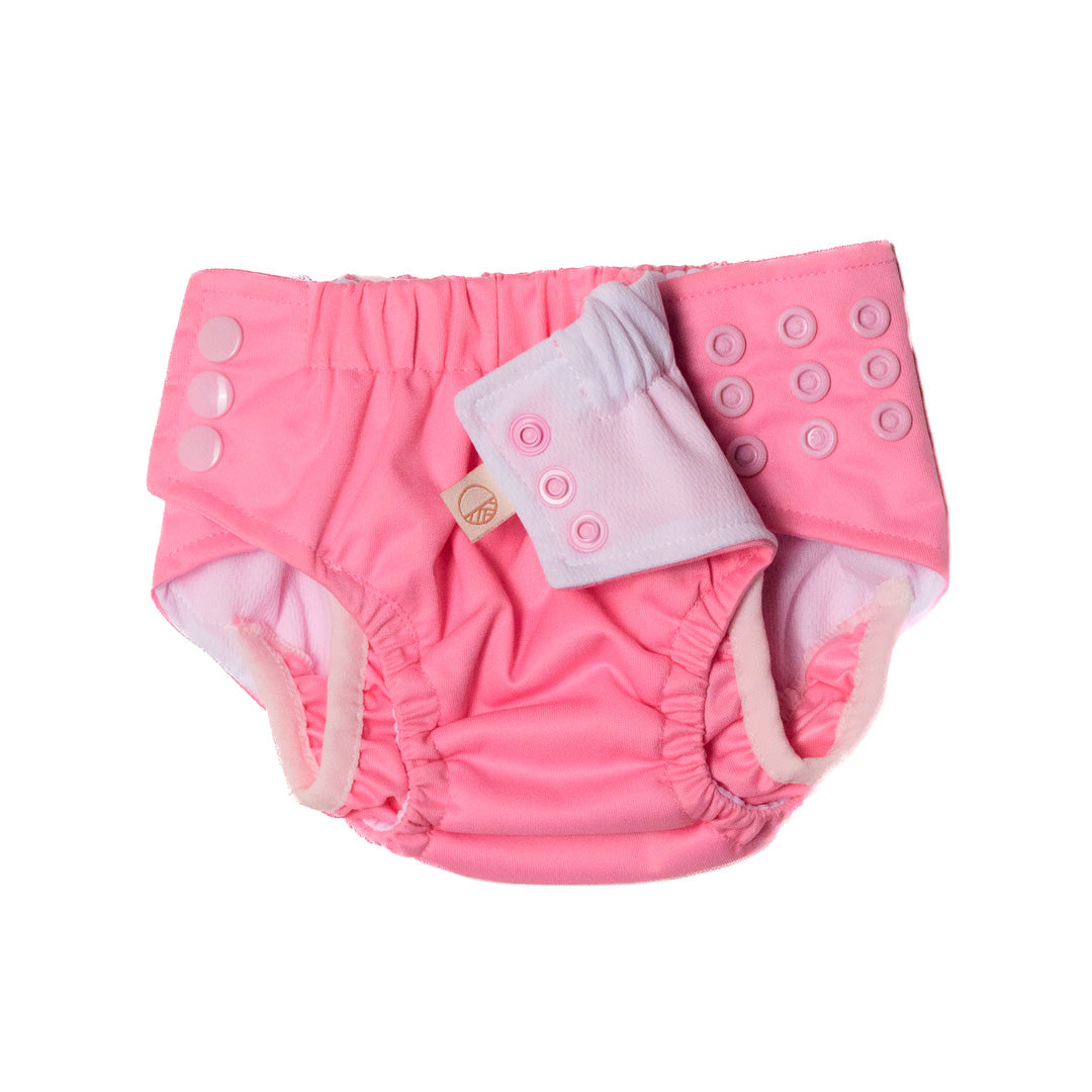Several rows of adjustable snaps on a pink reusable swim nappy on a white background