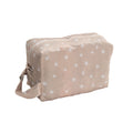 Beige toiletry bag with white star pattern on a white background