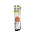 Colorful striped out and about change mat rolled up with a nestling brand logo on a white background