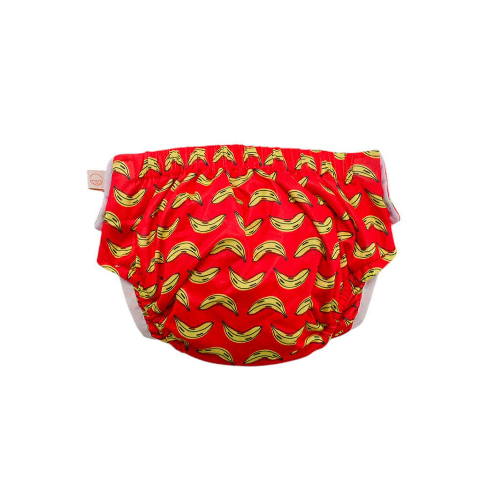 Red Nestling swim nappy with yellow banana pattern on a white background