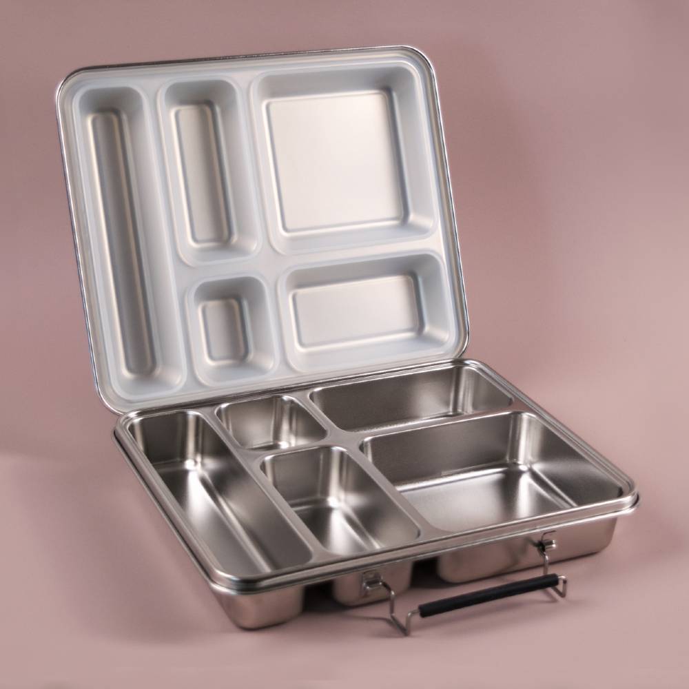 Stainless steel large compartmentalized bento lunch box on a pink background