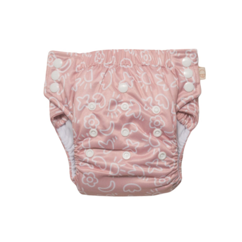 Pink reusable toddler pull-up style nappy with pop art pattern on a white background