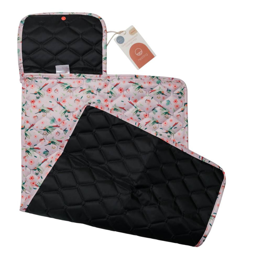 Floral-patterned quilted waterproof change mat with black reverse on a white background