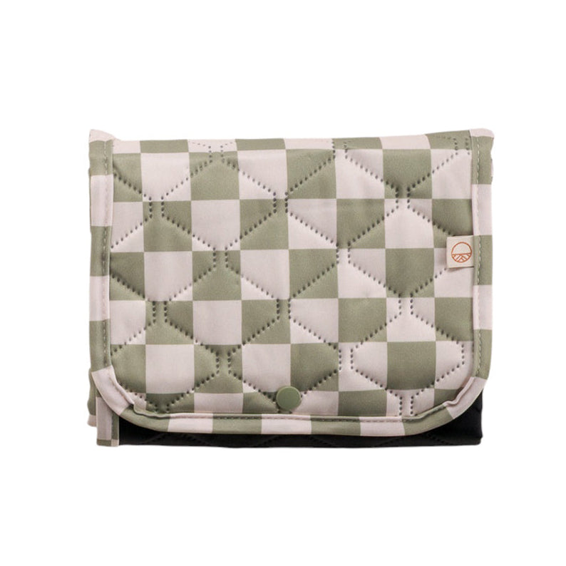 Quilted checkered portable change mat with green and white check pattern on a white background