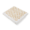 Folded fabric of 4 layer cotton muslin throw blanket with a beige checkered pattern on a white background
