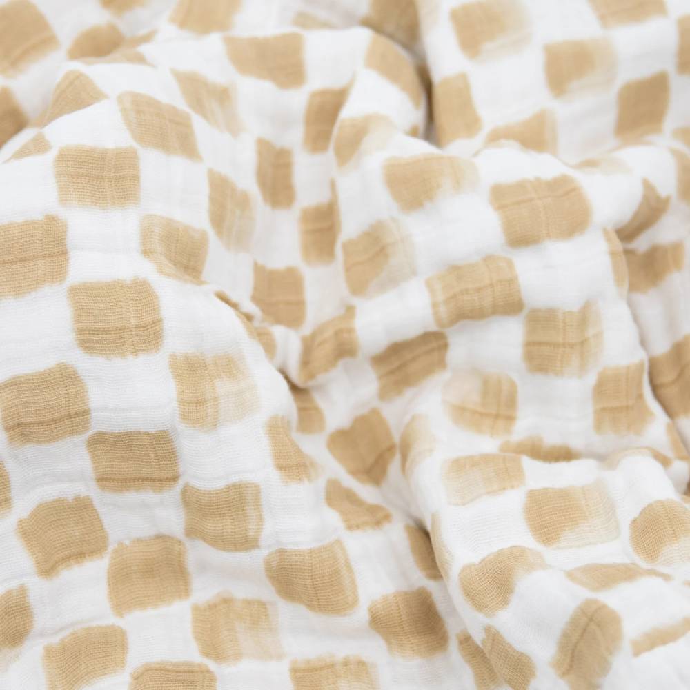 Close-up of beige and white checkered organic cotton muslin fabric