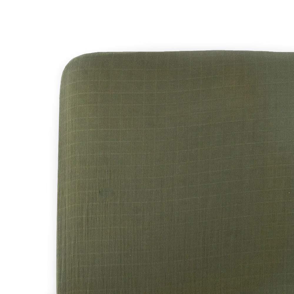 Close-up of a green fabric muslin cotton sheet on a white background