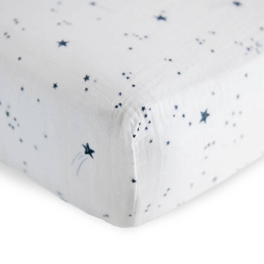 Close-Up cotton muslin fitted sheet with navy blue star pattern on a white background