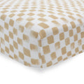 Close up of cotton muslin fitted sheet white and beige checkered pattern on a white background