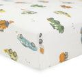 Close-up of Cotton muslin fitted sheet white with colorful truck pattern on a white background